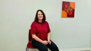 Anne, a professional social nurse sitting in a calm environment after completing a session with the NADA Protocol